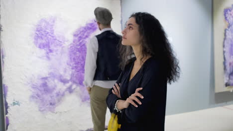 couple viewing abstract art in gallery