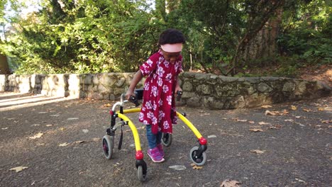 black girl with cerebral palsy walking in the park with her assistive device-3