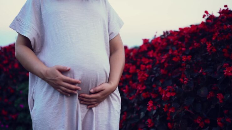 Happy pregnant woman and expecting baby at home.