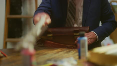 business man pulls papers out of his briefcase