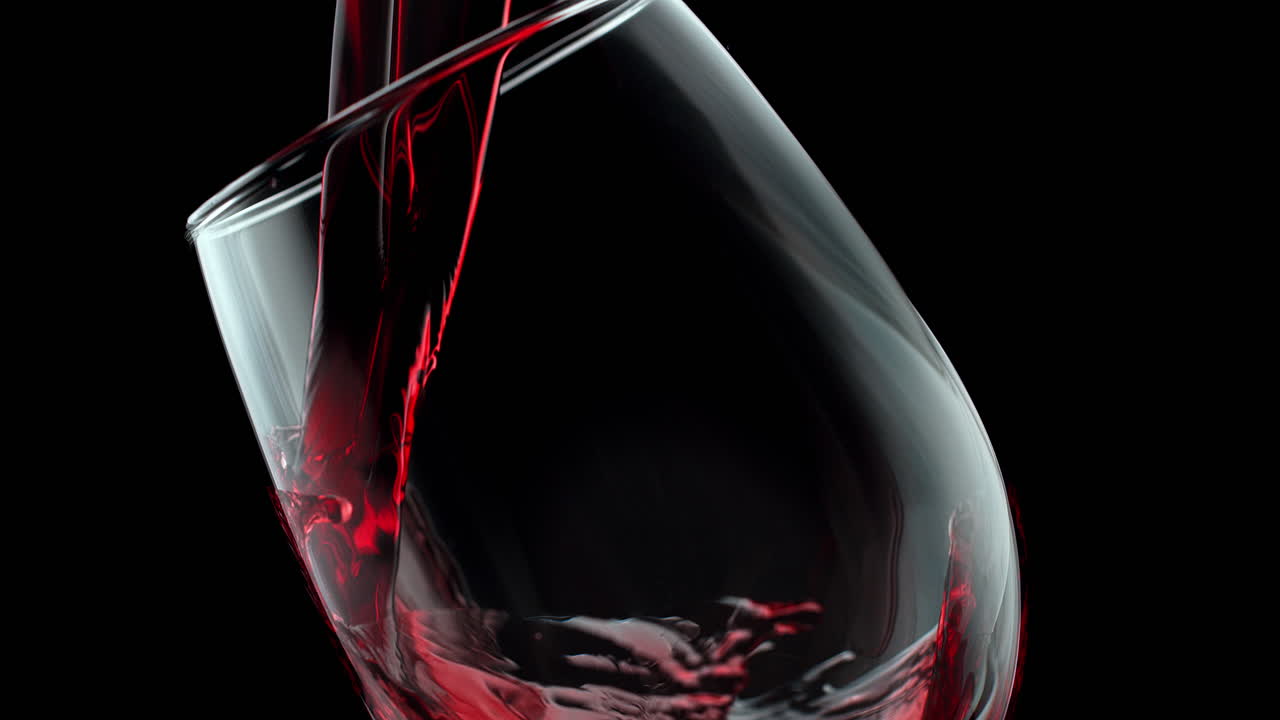 Pouring Red Wine Into A Crystal Glass On The Black Background In Slow Motion