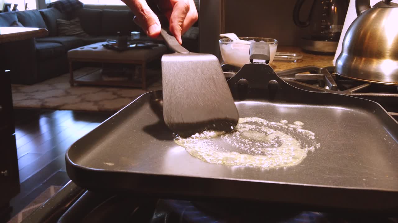 slow motion, melting butter on hot pan, in a kitchen, in the morning