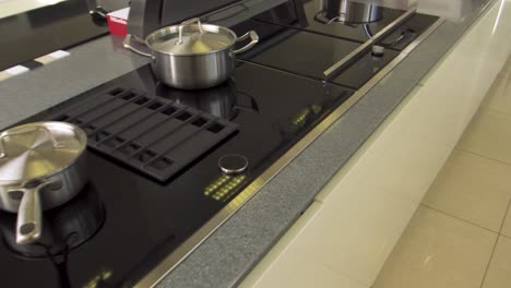 modern kitchen cooktop with pots and pans