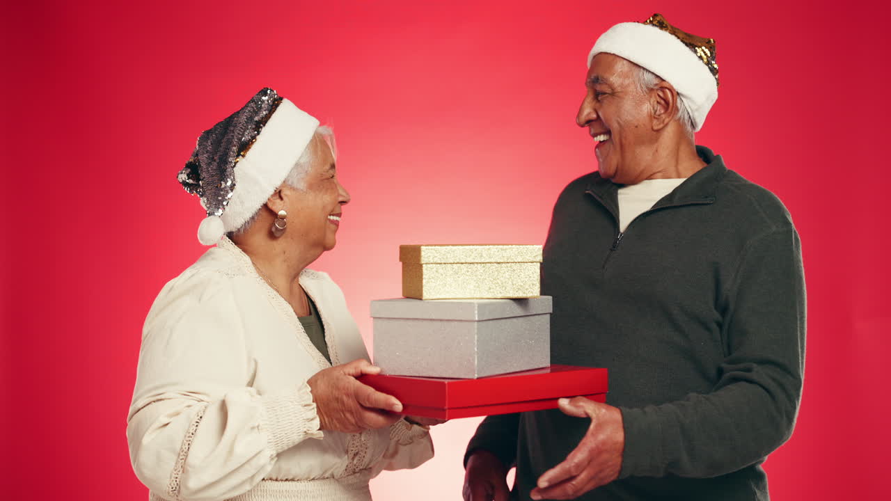 Senior Couple Exchanging Christmas Gifts