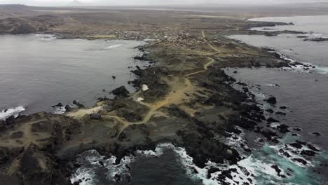 rustic golden rocky ocean headland at caleta chanaral village in chile