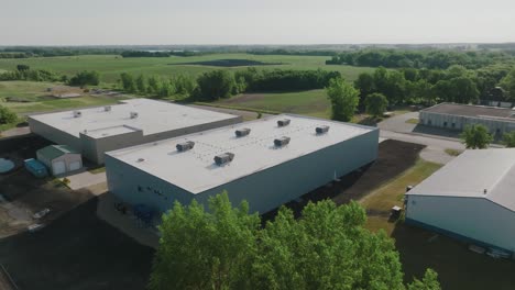 large commercial building with air conditioning units on the roof, push in drone shot