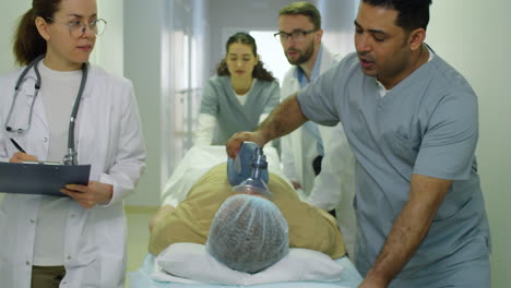 Sanitäter-Transportieren-Patienten-Auf-Einer-Trage-Durch-Das-Krankenhaus