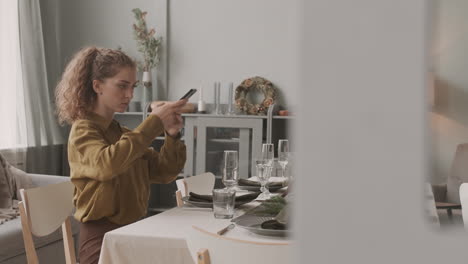 decorator photographing festive dining table