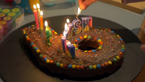 child's birthday cake lit with candles