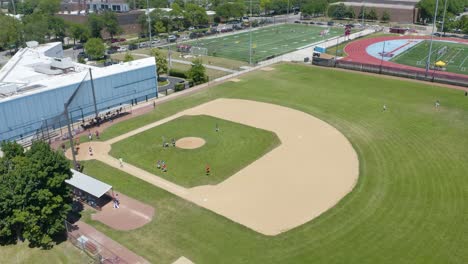 baseball players run into dugout during summer baseball game at sports complex