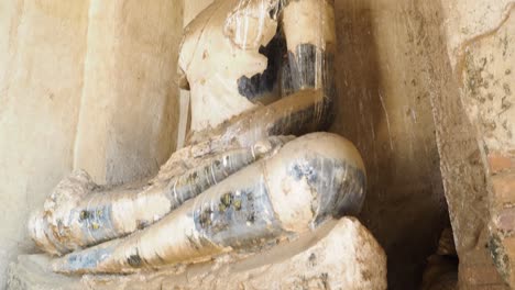 a weathered buddha statue in ayutthaya, thailand