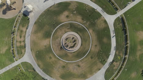 aerial - spiral drone shot of suburban park centerpiece