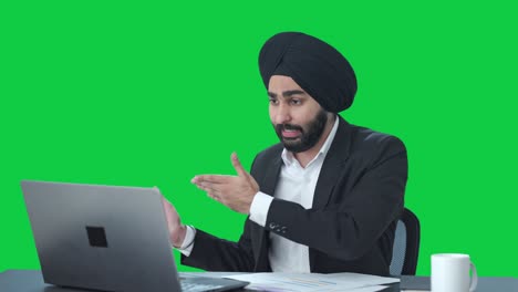 angry sikh indian businessman shouting on video call green screen