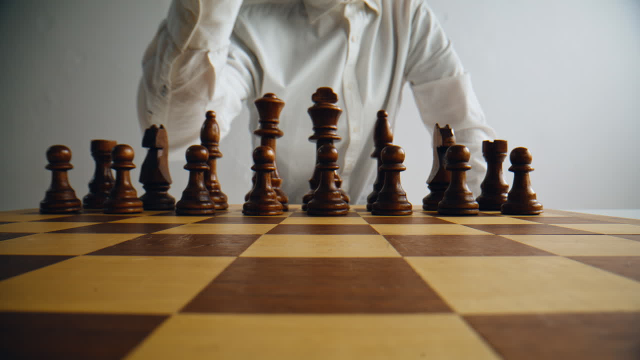 Unknown grandmaster playing chess at home. Man hand making move brainstorming