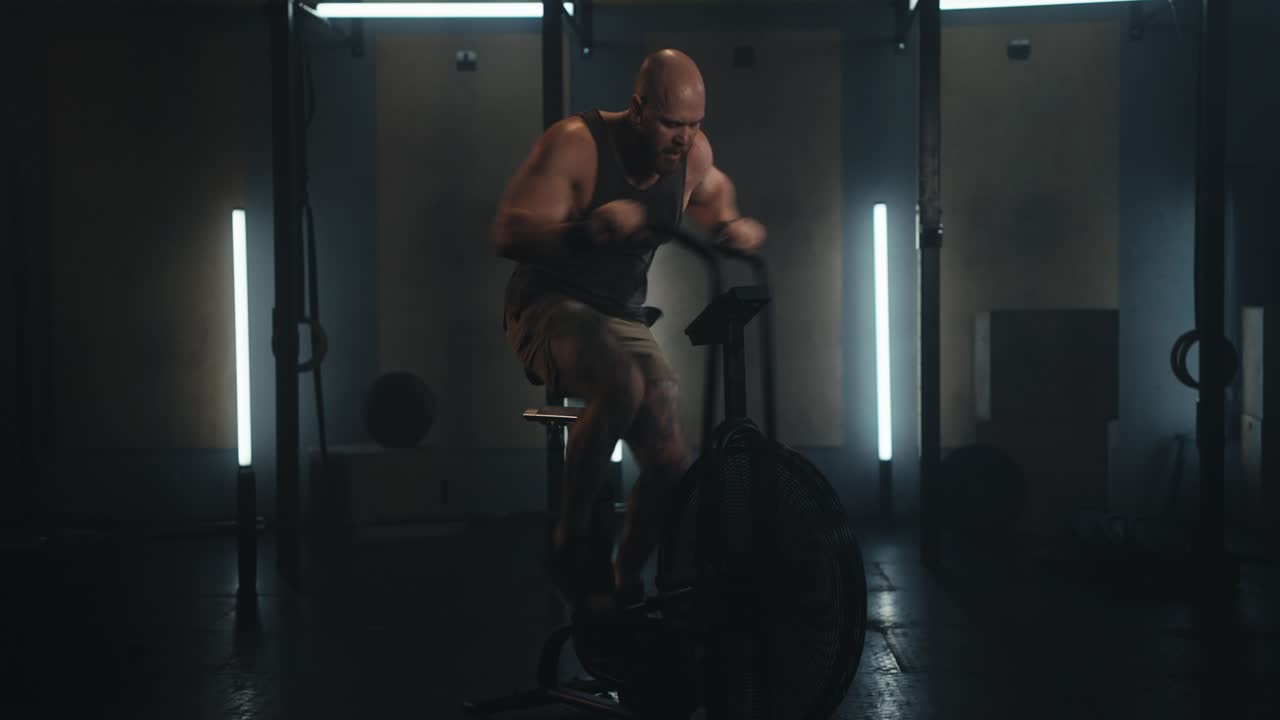 체육관 에서 운동 자전거 를 타고 운동 하는 사람