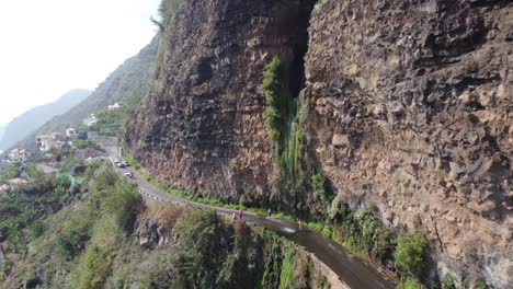a waterfall in the middle of the road in madeira