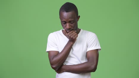 young sad african man thinking and looking down