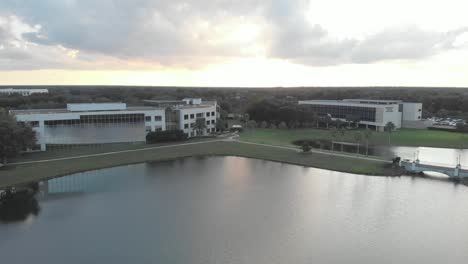 slow-push-in-to-business-building-sunset-sunrise-clouds-sky-orange-sun