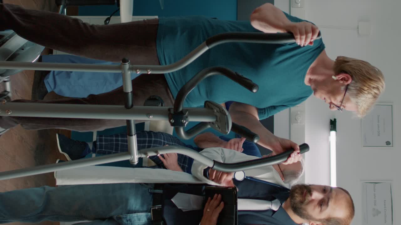 Male doctor examining senior woman on stationary bicycle