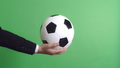 businessman holding soccer ball