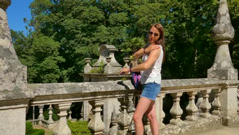 portrait of a tourist girl applying sunscreen cream on her arms