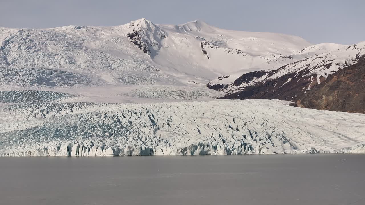 Frozen glacier front meeting icy lagoon waters near Vatnajökull in Skaftafell National Park. Iceland