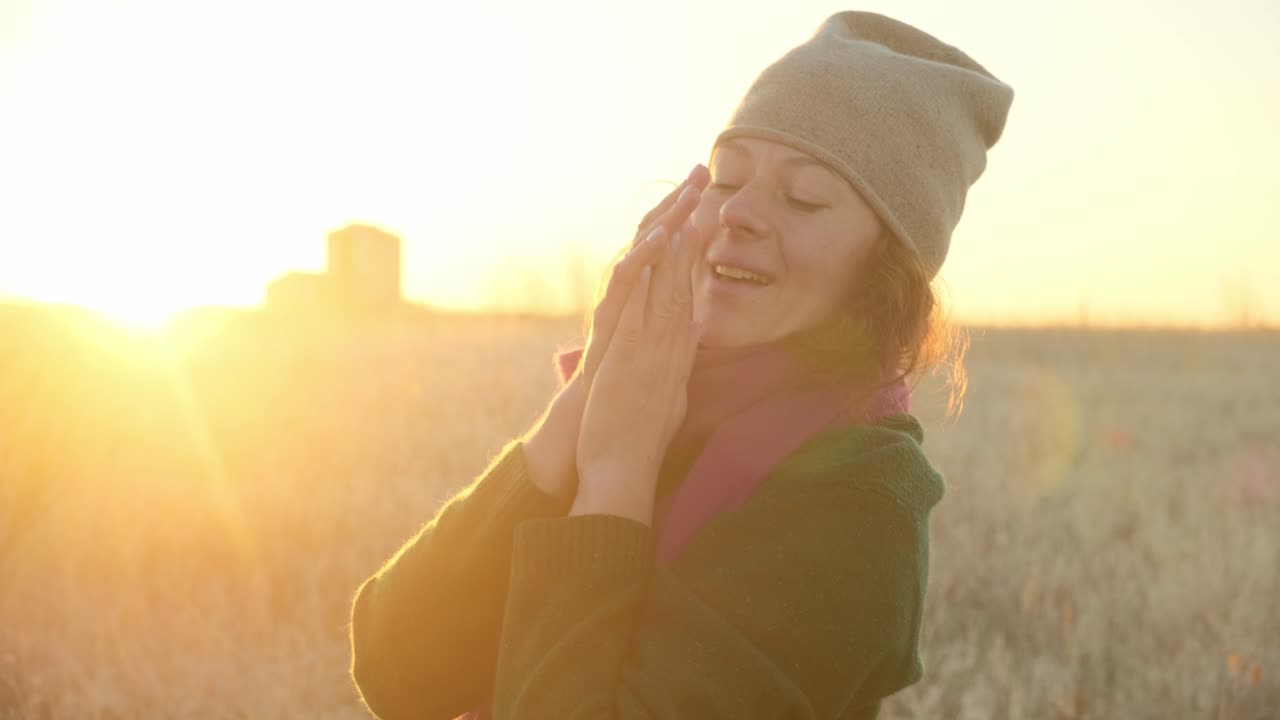 Woman enjoying a beautiful sunrise in a field