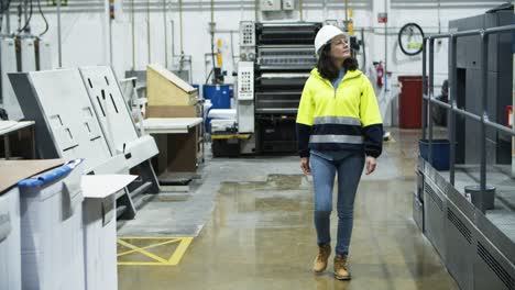 front view of female engineer walking at factory