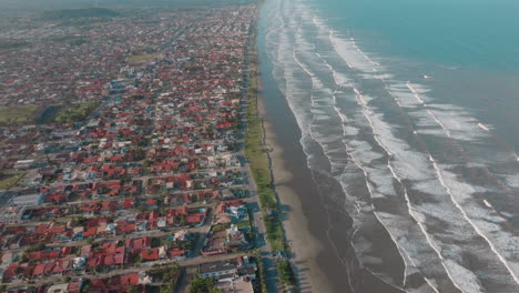 aerial view of a coastal city with residential areas alongside the ocean