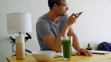Man-talking-on-mobile-phone-in-living-room-4k
