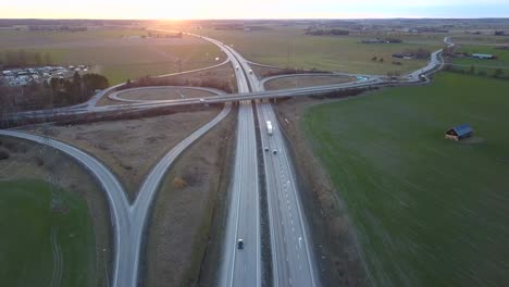 aerial view of freeway intersection with moving traffic cars.