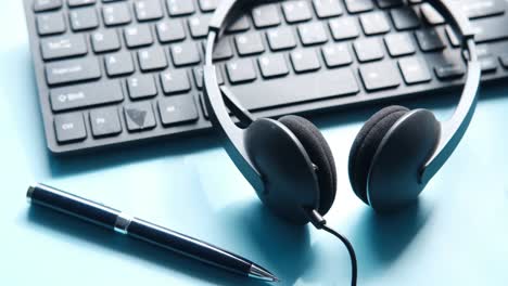 office workspace with keyboard, headset, and pen