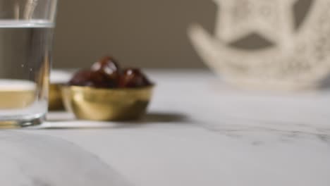 Bowl-Of-Dates-With-Sugar-And-Glass-Of-Water-Celebrating-Muslim-Festival-Of-Eid-With-And-Symbol-Of-Pakistan