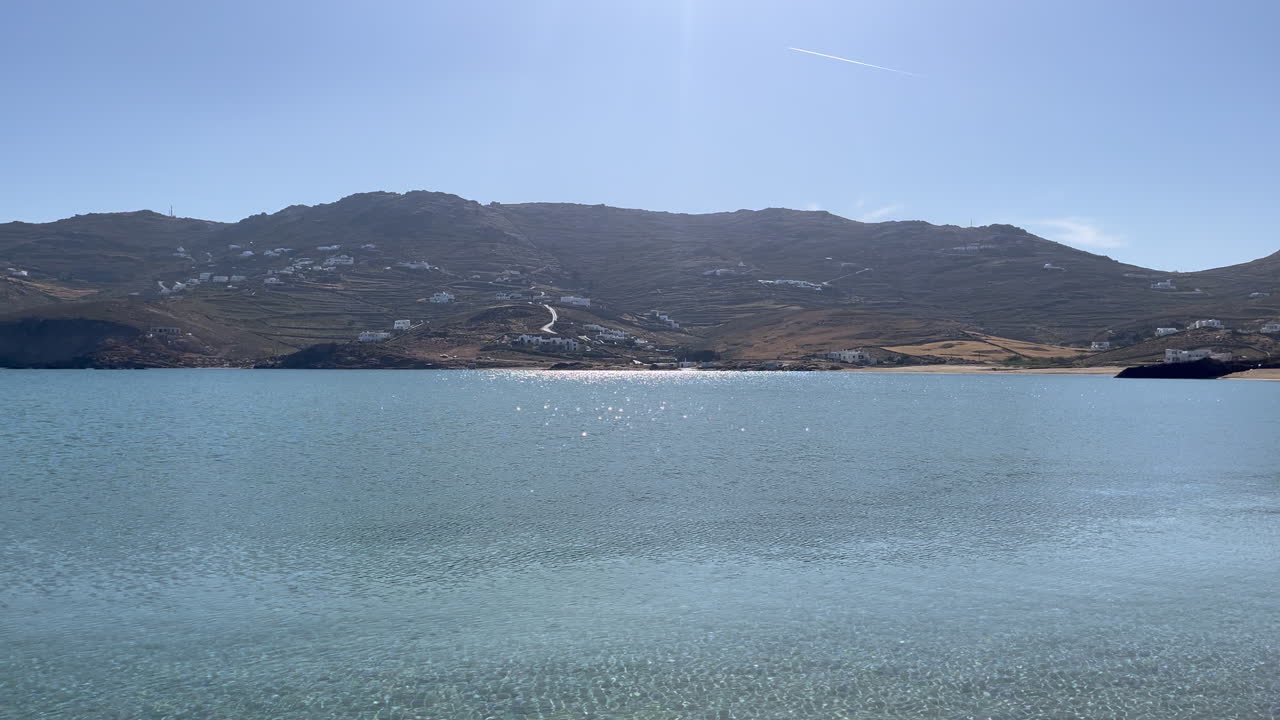 Glittering sunlight dances on calm waves at Ftelia beach, highlighting the peaceful essence of coastal nature. Perfect for travel promotions, wellness and mindfulness videos, and influencer content