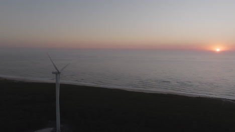 coastal wind turbine at sunrise/sunset