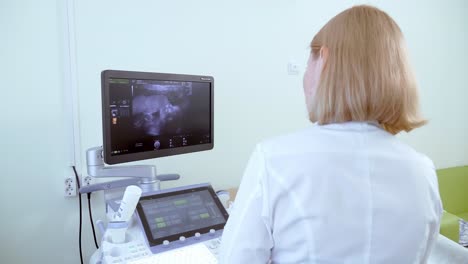 doctor performing ultrasound scan on patient