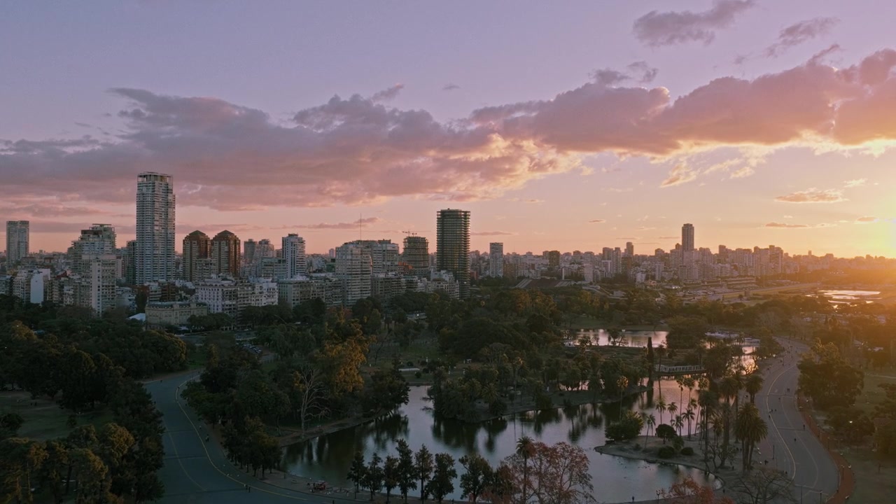 Ripresa aerea con drone dei laghi del Parque Tres de Febrero, del verde e dello skyline di Palermo a Buenos Aires durante un tramonto dorato con il panorama urbano della capitale argentina