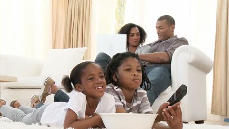 afroamerican children watching a film at home