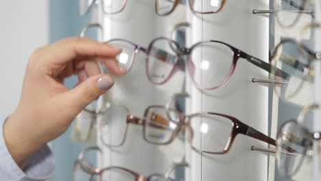 mujer eligiendo gafas en una tienda de óptica