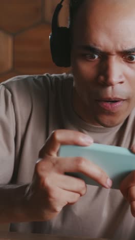 engaging gameplay session at home with headphones and mobile device