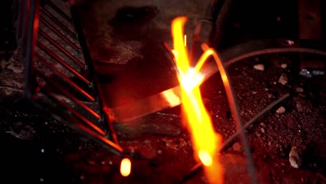 close up shot of iron welding process, worker welds metal