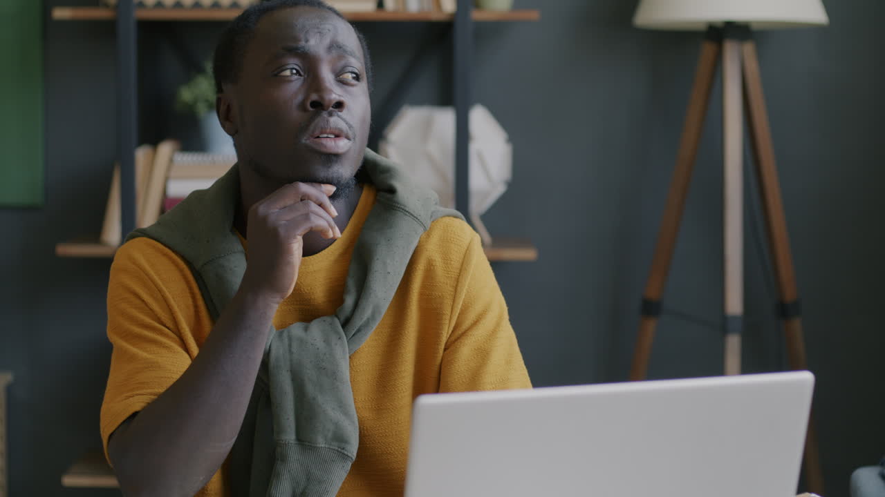 Man Thinking at Laptop