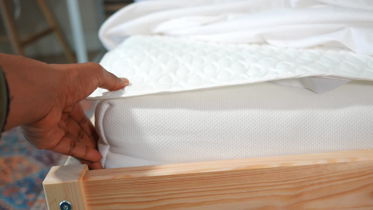Close-up of a bed with a mattress and sheets