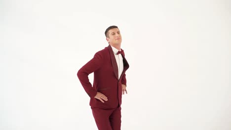 cheerful man in a red suit is making exercises with his hands on the sides on a white background. caricature of a man who doing physical exercises