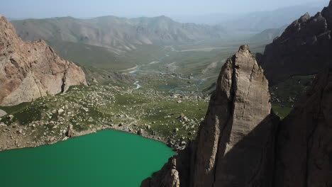 rotating revealing cinematic drone shot inside the kel-suu lake and its ravine's rocks in kyrgyzstan