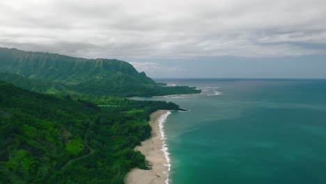 high altitude aerial dolly backwards along beach at hanalei bay, hawaii