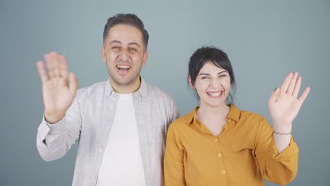 couple waving at camera.