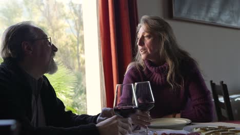 elderly couple having dinner in restaurant