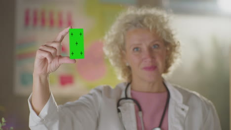 doctor showing a green screen medical card