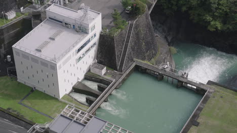 ogouchi reservoir by lake okutama - water flow control facility at the reservoir seen from ogouchi dam observation tower in hara, okutama, japan